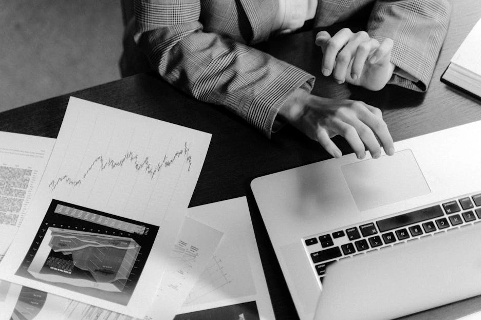 A marketing professional using a dashboard to analyze market trends on a laptop.